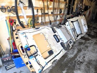 Wooden frame with a partially finished white fiberglass shell.