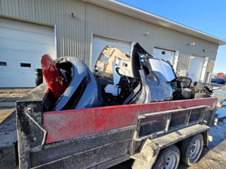 Damaged snowmobile on a trailer