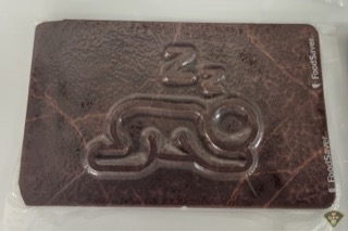 Dark chocolate bar with a raised logo.