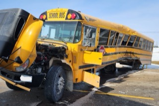 Damaged yellow school bus with deployed stop sign