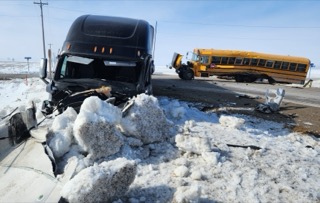 Two school buses collided, surrounded by snow.