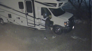 Damaged RV on the side of a road.