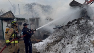 Firefighters extinguish a house fire.