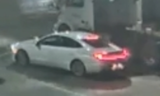 White sedan with red taillights.
