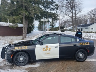 Ontario Provincial Police cruiser parked on a snowy street.
