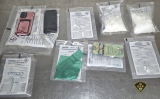 Small packages of cash and a wallet on a table
