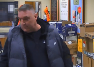 Man in a blue puffer jacket and black hoodie