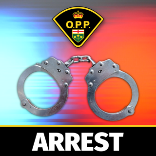 Pair of handcuffs against a red and black background.
