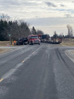 Red dump trucks on a paved road.