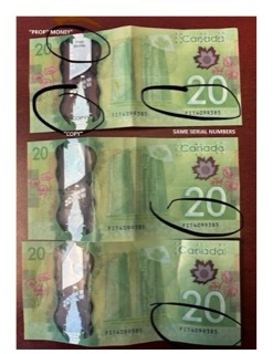Two Canadian twenty-dollar bills, same serial number