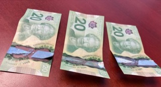 Three Canadian twenty-dollar bills