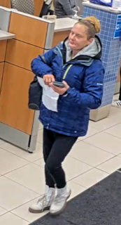 Person in a blue jacket and black leggings.