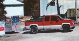Red pickup truck with black wheels and bed liner.