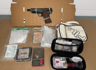 Firearm and drug paraphernalia inside a cardboard box