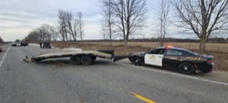 Tow truck and police car on the side of a road