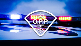 Ontario Provincial Police logo over blurred emergency lights