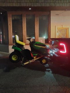 John Deere tractor parked in a driveway