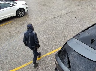 Person walking across a parking lot