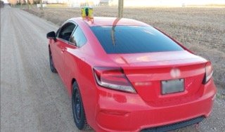 Red Honda Civic coupe with black wheels