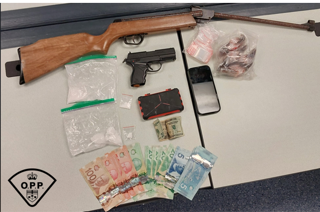 Air rifle, cash, and baggies on a surface