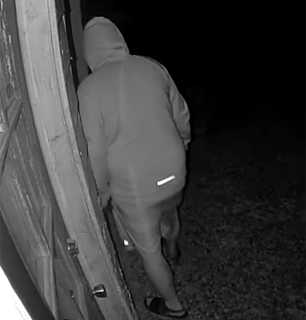 Person leaning against a wooden door