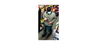 Person wearing a black hat and face mask, looking at ice cream.