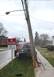 Red pickup truck collided with a utility pole, no passing here crossing sign