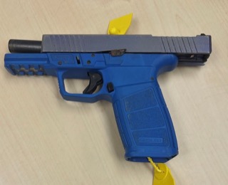 Blue pistol with yellow security tag