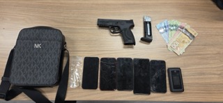 Black designer bag, handgun, stack of cash, cracked smartphones