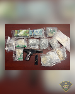 Pile of cash and drugs, including packages of what appears to be cannabis and white powder.