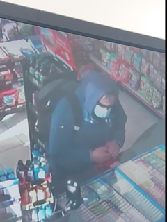 Person in a dark blue hoodie and face mask.