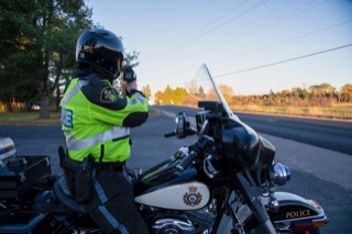 Police officer on a motorcycle, facing forward