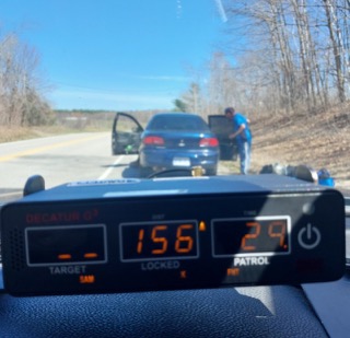 Dashboard displaying numbers, patrol car facing a dark SUV on a road.