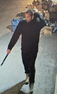 Man walking, holding a knife.