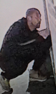 Man in dark clothing, side profile