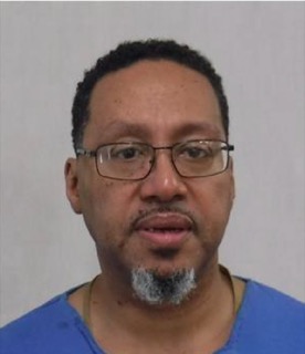 Man with glasses and goatee, blue shirt