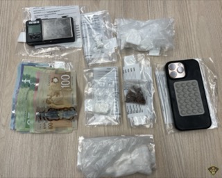 Canadian money, scales, and a smartphone on a surface