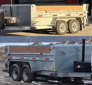 Double axle dump trailer with lumber inside.