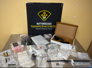 Stacked Canadian fifty-dollar bills and baggies on a table. Ontario Provincial Police logo. Nottawasaga Community Street Crime Unit.
