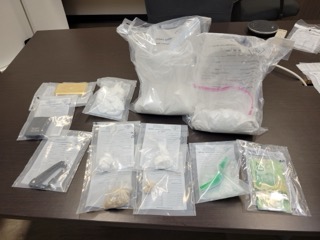 Several sealed plastic bags on a dark surface.
