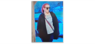Person with red hair and sunglasses.