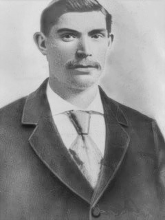Man in a suit with a mustache