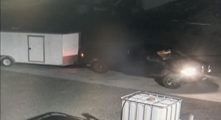 Trailer and pickup truck at night