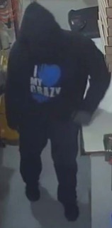 Person in a black hoodie, blue text reads &quot;I ❤️ CRAZY&quot;