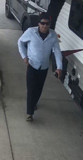 Man in a light blue shirt and black pants