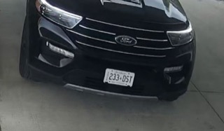 Black Ford Explorer, front view, license plate reads 233 DST