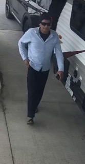 Man in a light blue shirt and black pants