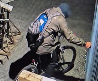 Person bending over a bicycle