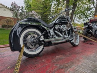 Custom black motorcycle with whitewall tires.