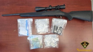Rifle with scope, packages of drugs, handcuffs